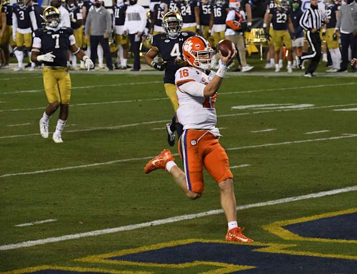 Dec 19, 2020; Charlotte, NC, USA; Clemson quarterback Trevor Lawrence (16) runs 34-yards for a touchdown against Notre Dame during the third quarter of the ACC Championship game at Bank of America Stadium.